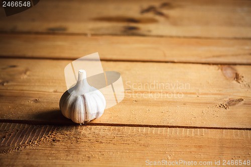 Image of Raw garlic on wooden background