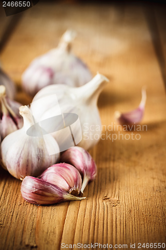 Image of Raw garlic on wooden background