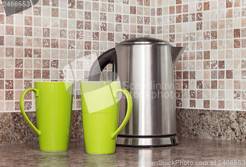 Image of Electric kettle and cups in the kitchen