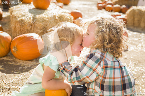 Image of Sweet Little Boy Kisses His Baby Sister at Pumpkin Patch
