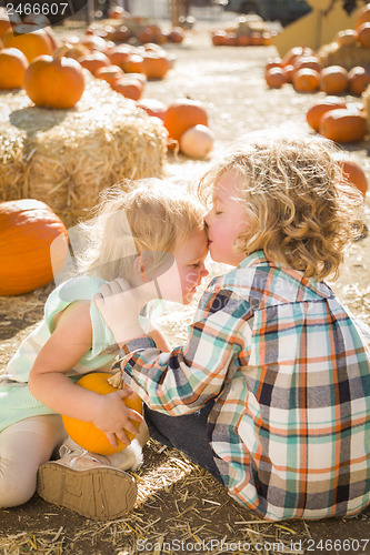 Image of Sweet Little Boy Kisses His Baby Sister at Pumpkin Patch
