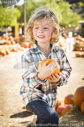 Image of Little Boy Holding His Pumpkin at a Pumpkin Patch
