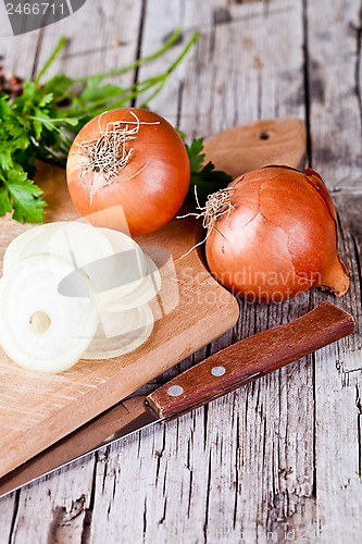 Image of fresh onions, knife, and parsley