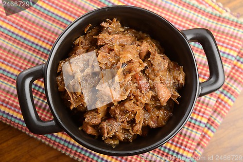 Image of traditional polish sauerkraut (bigos) with mushrooms and plums f