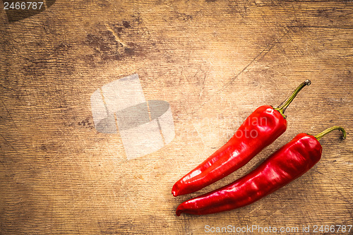 Image of Red peppers on old wooden table