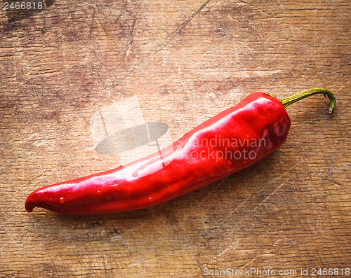 Image of Red peppers on old wooden table