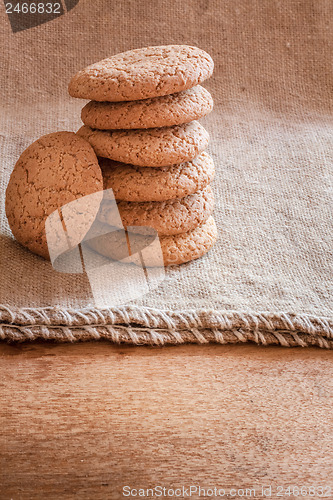 Image of Stacked Brown Cookies On Rustic Background