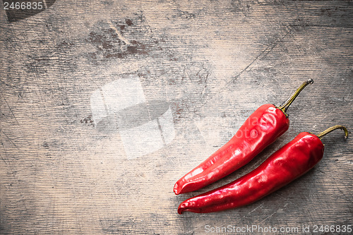 Image of Red peppers on old wooden table