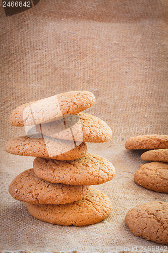 Image of Stacked Brown Cookies On Rustic Background