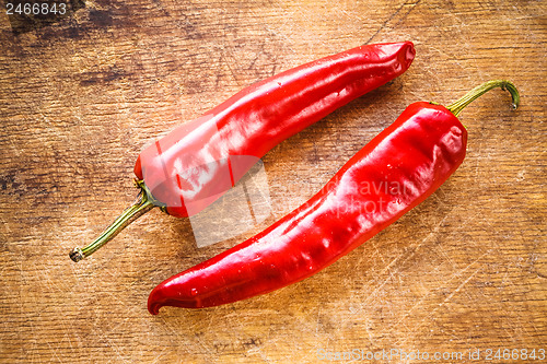 Image of Red peppers on old wooden table