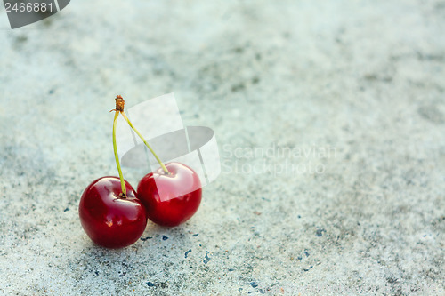 Image of Two Cherries On Gray Background