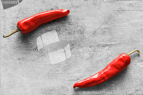 Image of Red peppers on old wooden table