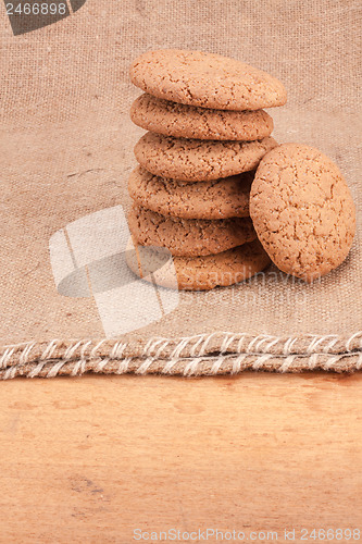 Image of Stacked Brown Cookies On Rustic Background