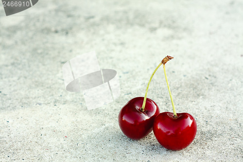 Image of Two Cherries On Gray Background