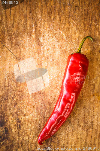 Image of Red peppers on old wooden table