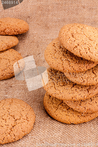 Image of Stacked Brown Cookies On Rustic Background