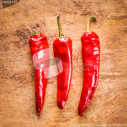 Image of Red peppers on old wooden table