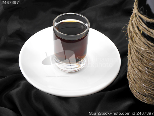 Image of wine bottle and wine glass on white plate