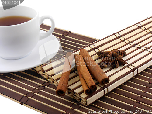 Image of tea cup with cinnamon and star anis on bamboo background