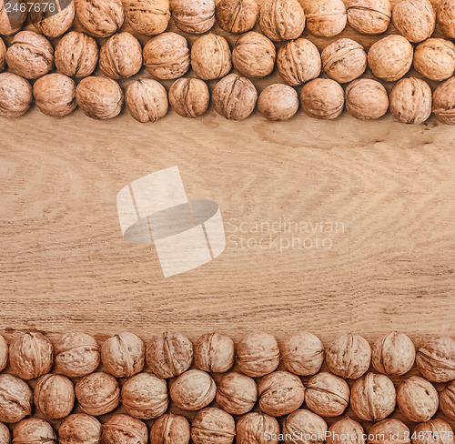 Image of Unshelled Walnuts Lying On Desk