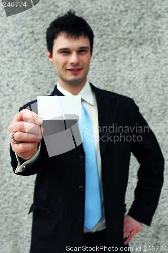 Image of Businessman holds a blank card - add your own text.