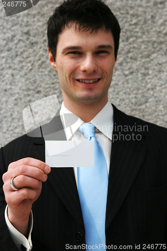 Image of Businessman holds a blank card - add your own text.