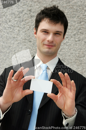 Image of Businessman holds a blank card - add your own text.