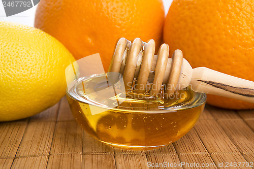 Image of fresh honey with lemon and orange fruits