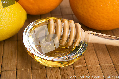 Image of fresh honey with lemon and orange fruits