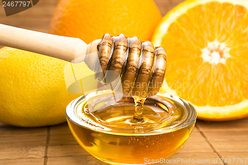 Image of fresh honey with lemon and orange fruits