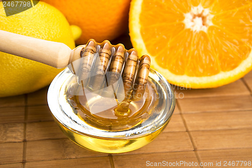 Image of fresh honey with lemon and orange fruits