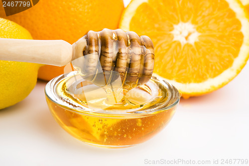 Image of fresh honey with lemon and orange fruits