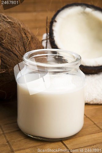 Image of coconut fruit with a jar filled with coco milk