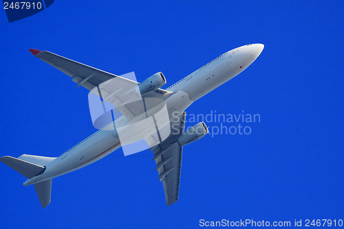 Image of Passenger jet air plane flying on blue sky