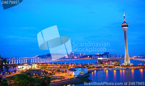 Image of Cityscape in night with famous travel tower near river in Macao,