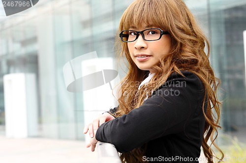 Image of young business woman and an office background