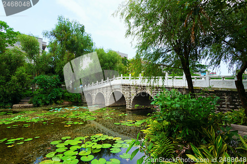 Image of stone bridge in an Asian garden 