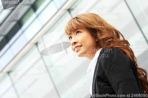 Image of young business woman and an office background