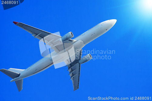 Image of Passenger jet air plane flying on blue sky