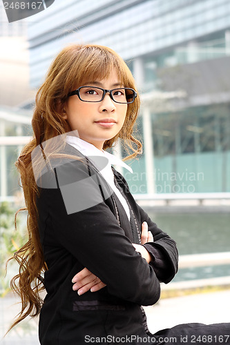 Image of young business woman and an office background