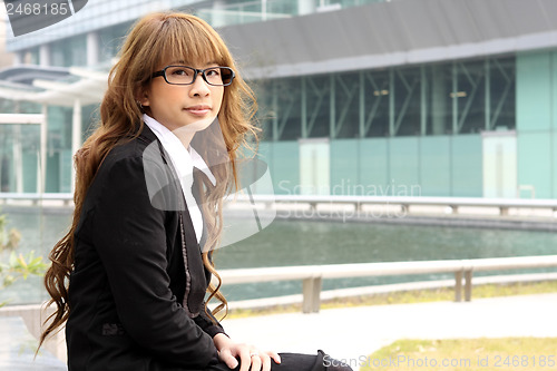 Image of young business woman and an office background