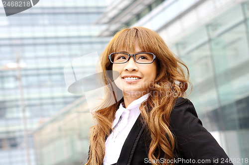 Image of young business woman and an office background