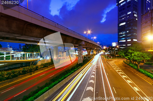 Image of moving car with blur light through city at night 