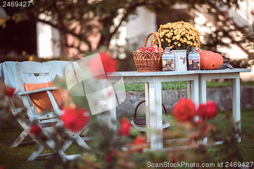 Image of flowers, apples on table