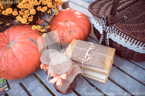 Image of flowers, pumpkins, jams and books