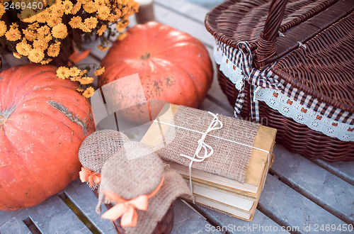 Image of flowers, pumpkins, jams and books