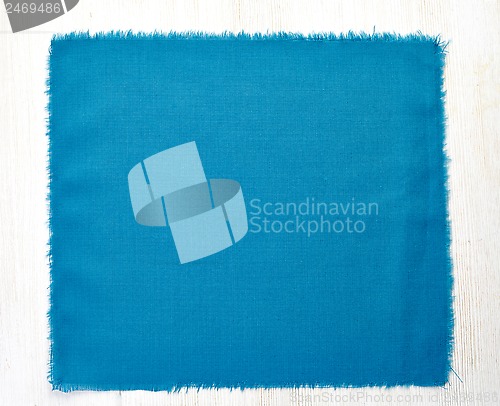 Image of blue napkin on white wooden table