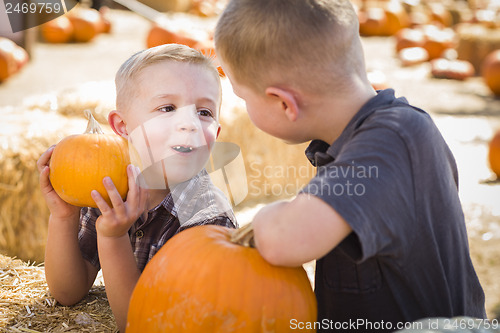 Image of Two Boys at the Pumpkin Patch Talking and Having Fun
