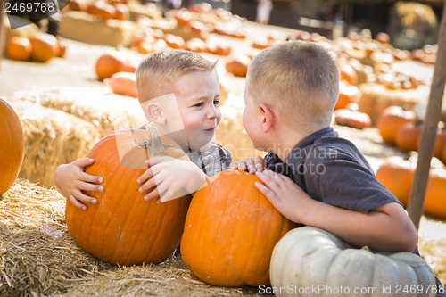 Image of Two Boys at the Pumpkin Patch Talking and Having Fun
