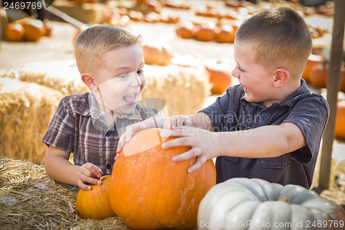 Image of Two Boys at the Pumpkin Patch Talking and Having Fun
